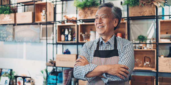 Shop owner smiling with arms crossed