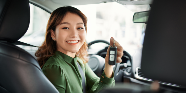 Woman with new car holding keys