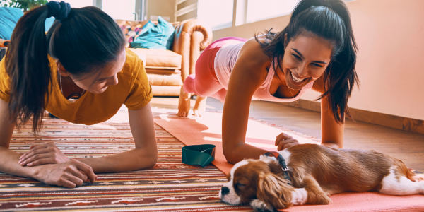 Women working out at home with dog