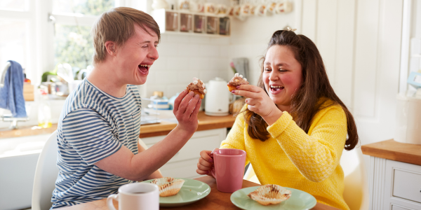 two people making a cheers with muffins
