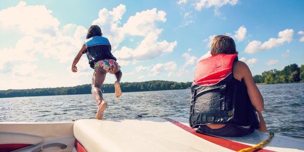 kids jumping off boat