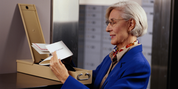 woman looking at documents in her safe deposit box