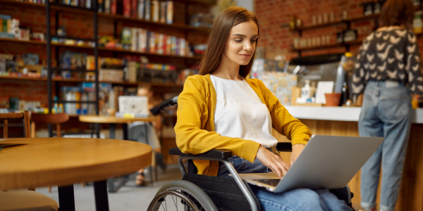 Woman in wheelchair looking at her eStatments on a laptop