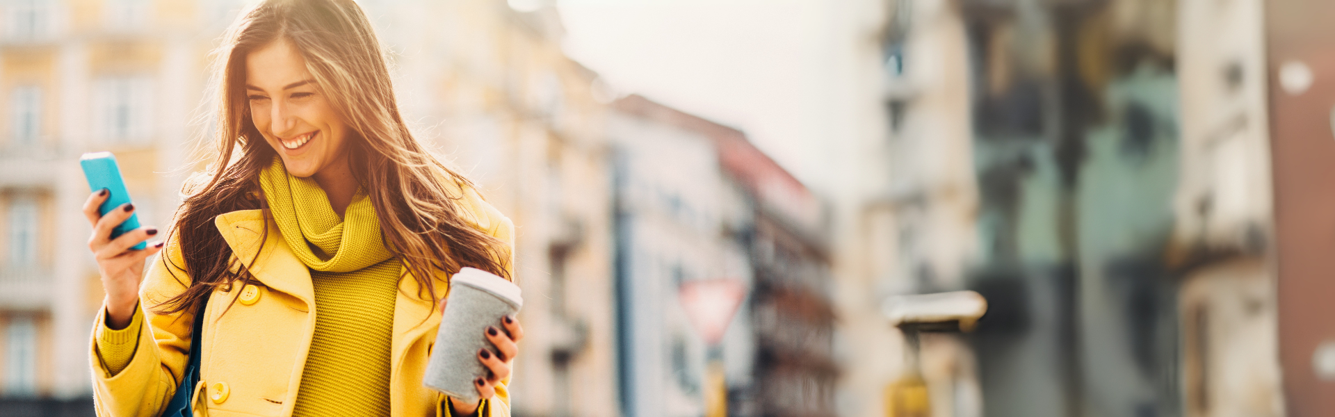 Woman using the Star Bank MN app and holding a coffee